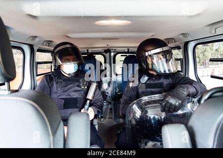 swat policeman in helmet body armor and medical mask going to operation with assault rifle Stock Photo