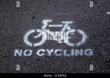 a No cycling sign spray painted on a footpath Stock Photo