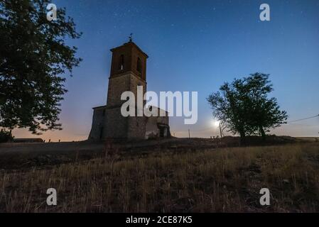 Low view of bell tower on the hill under spectacular scenery with starry night sky Stock Photo