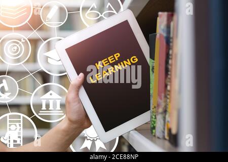 Student Taking Tablet From Book Shelf In Library, Cropped, Collage Stock Photo