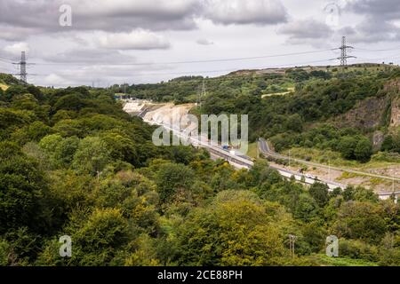 Construction machinery and crews work on dualing the A465 Heads of the Valleys Road in the Clydach Gorge in South Wales. Stock Photo