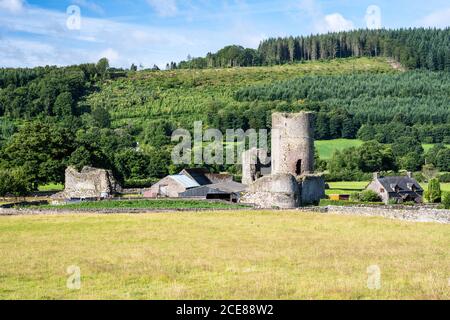 Sun shines on the Myarth hill and the stone ruins of Tretower Castle in the Brecon Beacons of South Wales. Stock Photo