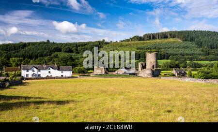 Sun shines on the Myarth hill and the stone ruins of Tretower Castle in the Brecon Beacons of South Wales. Stock Photo