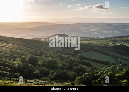 Sunset casts a golden glow over the Wye Valley and the foothills of the Black Mountains of Wales. Stock Photo
