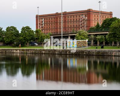 The 'A Bond', one of 3 landmark bonded warehouses, is reflected in the Cumberland Basin of Bristol's 'Floating Harbour' docks. Stock Photo
