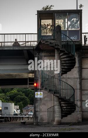 A concrete spiral staircase leads from the quayside of Cumberland Basin to the Pimsoll Bridge flyover on Bristol's Floating Harbour. Stock Photo