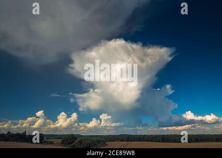 Cumulonimbus storm clouds in evening light with sun rays Stock Photo