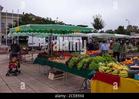 Angers, France - August 29 2020: people wearing face protective mask while shopping in the market place at France to prevent coronavirus, concept of wearing masks outdoor is mandatory, post-confinement mask mode in Europe, lifestyle, new reality Stock Photo