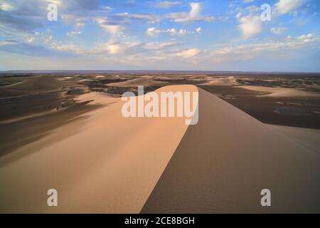 Minimalistic desert landscape with sandy dunes and clear blue sky in Hami, Xinjiang in China Stock Photo