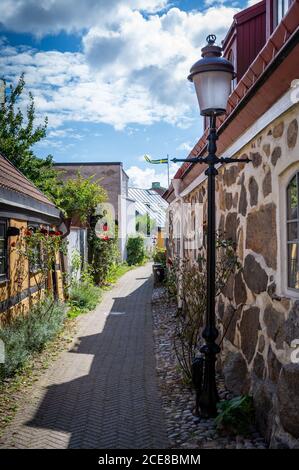 A narrow alley winds its way through the small half-timbered cottages of Ystad, Sweden