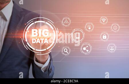 Big Data. Unrecognizable businessman pressing button on digital screen with virtual icons Stock Photo