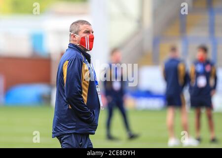 Tony Smith head coach of Hull KR inspect the pitch while wearing a face mask Stock Photo