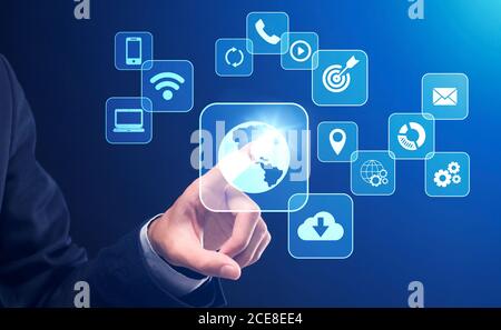 Business Technologies. Businessman pushing button on digital screen interface with various icons Stock Photo