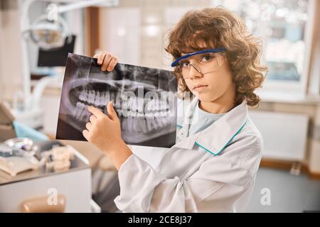 Little boy is standing in dental clinic Stock Photo