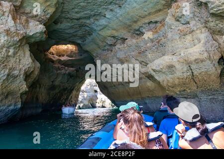 A group of tourist in a boat visiting the caves of Benagil Stock Photo