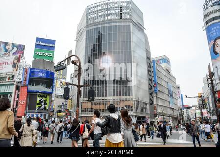 Shibuya, Tokyo, Japan - Shibuya scramble crossing. Many people at one of the busiest areas in the world. Crowded and full of advertising billboards. Stock Photo
