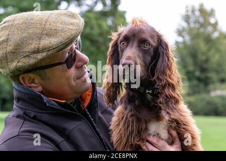 Portrait of a working Cocker Spaniel and owner, Abington Park, Northampton, England, UK. Stock Photo