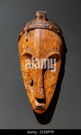 Santa Cruz de Tenerife/Spain; March 22 2019: Antique  african Fang Ngil wooden mask, from Equatorial Guinea,  on grey wall surface Stock Photo