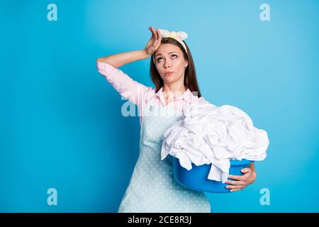 Portrait of her she nice attractive pretty tired overworked maid carrying holding in hands dirty laundry pile textile sheets isolated over bright Stock Photo