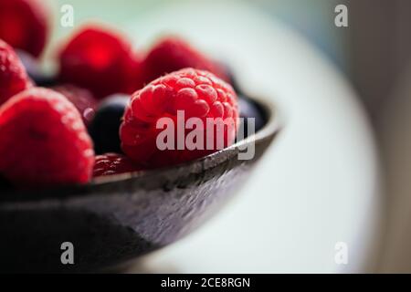 Bowl with yummy ripe blueberries and raspberries Stock Photo