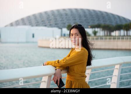 Abu Dhabi, United Arab Emirates - November 30, 2019: Asian female traveler visiting Louvre museum in Abu Dhabi emirate of the United Arab Emirates at Stock Photo