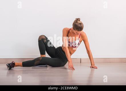 Slim Woman doing pose on yoga mat Stock Photo