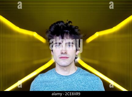 Handsome young man with blue eyes and curly wavy hair Stock Photo - Alamy