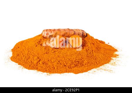 Curcuma powder with roots isolated on white Stock Photo