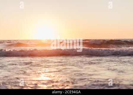 Ocean waves in sunset Stock Photo