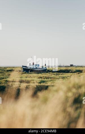Sailboat in green bay of ocean coast Stock Photo