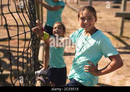 Portrait of girls net climbing during obstacle course at a boot camp Stock Photo