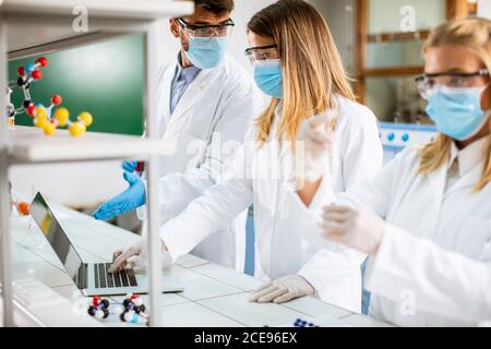 Young researchers analyzing chemical data in the laboratory Stock Photo