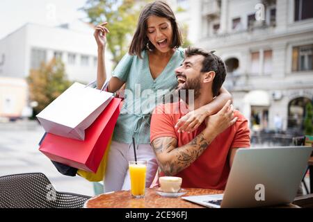Couple having fun at a restaurant. Shopping, date, work, happy people concept. Stock Photo