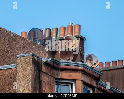 Glasgow, Scotland, UK. 12th August 2020: Close-up shot of a group of tv aerials on a tenement roof. Stock Photo