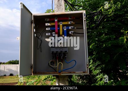 a close shot of opened electrical metre box isolated on pole Stock Photo