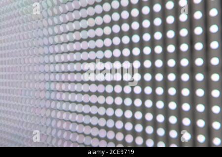 Close-up of an LED wall where you can see the evenly arranged light emitting diodes in many lines. Stock Photo