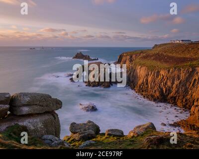 The coastline at Land's End in golden evening light. Stock Photo