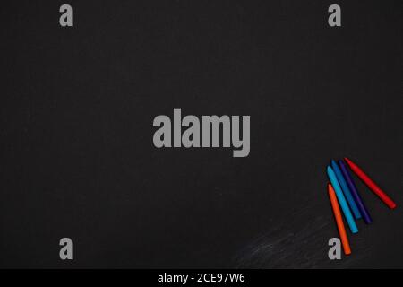 Black board background chalkboard with colored crayons for drawing. Free space. Back to school Banner. First September. Stock Photo