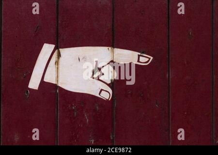 Old direction sign on a factory gate. Stock Photo