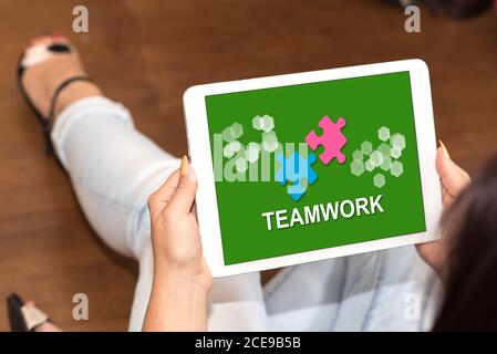 Tablet screen displaying a teamwork concept Stock Photo