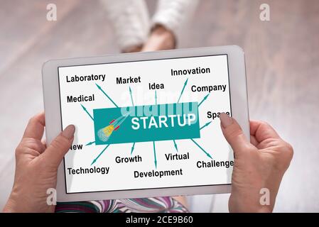 Start up concept shown on a tablet held by a woman Stock Photo
