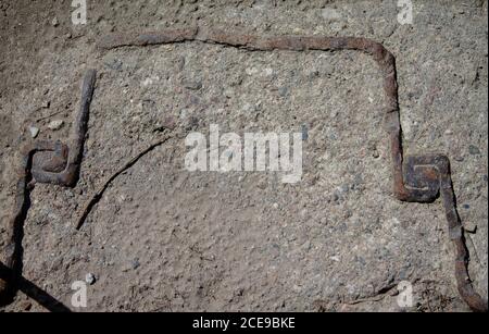 Texture iron fittings in concrete. Old and rusty. Stock Photo