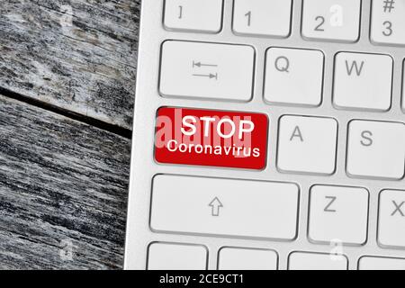 Stop coronavirus words on red button computer keyboard close-up Stock Photo