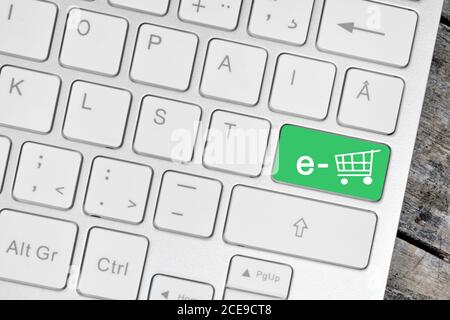E-commerce on green button keyboard computer close -up Stock Photo