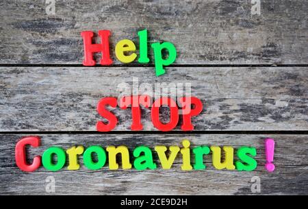 Help Stop Coronavirus words on an old wooden table Stock Photo
