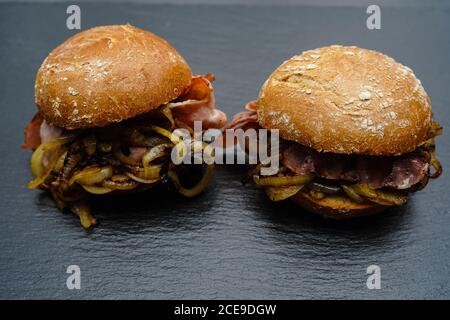 Baconburger - grilled burgundy Bacon and roasted onions in a rye roll Stock Photo