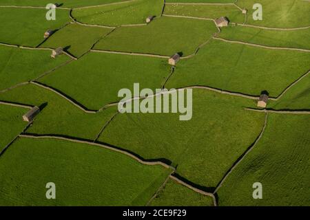 Aerial view of Swaledale, Stone Barns and dry stone walls in Gunnerside in the Yorkshire Dales, England. Old barns and drystone wall patterns Stock Photo