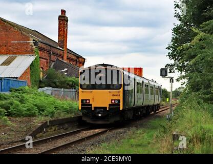 A Northern train passes the closed station at Midge Hall, near Leyland in Lancashire where there is the possibility of the station reopening Stock Photo