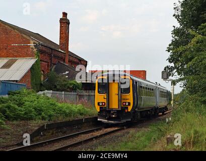 A Northern train passes through the closed station, Midge Hall near Leyland in Lancashire could this station be reopened to reverse a Beeching cut? Stock Photo