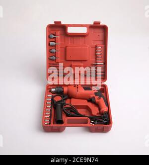 A red box of drill and accessories isolated on white background Stock Photo